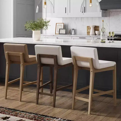 Taburete de bar tapizado de madera a la altura del mostrador